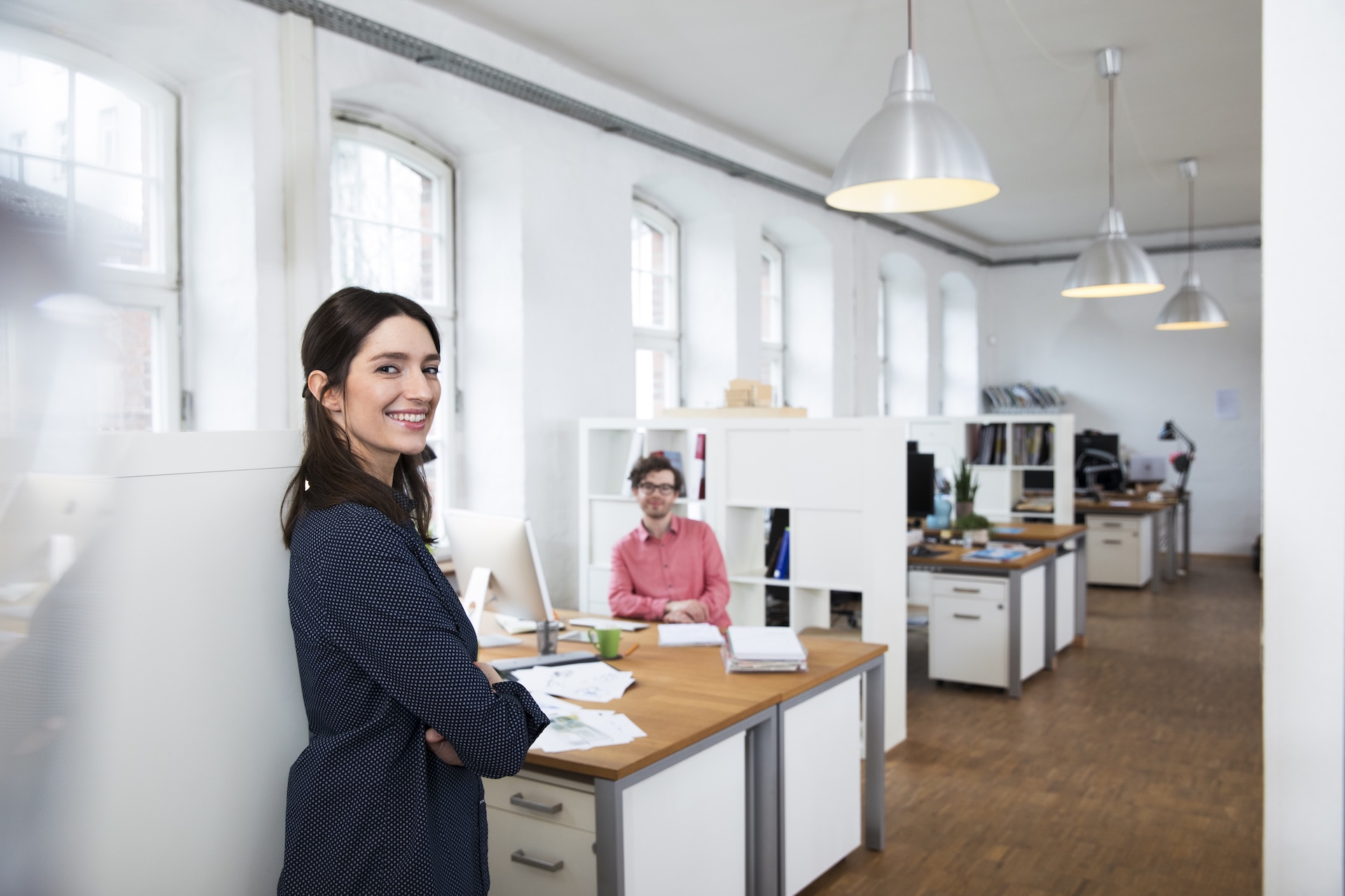 Portrait of smiling woman and man in office